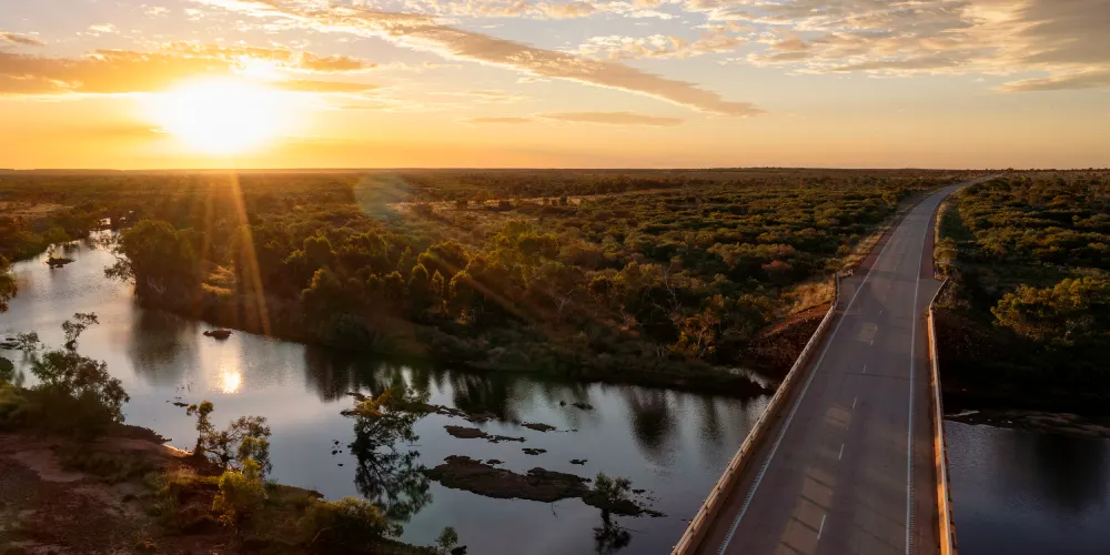 Scenic view of the sun rising over an NT landscape and road